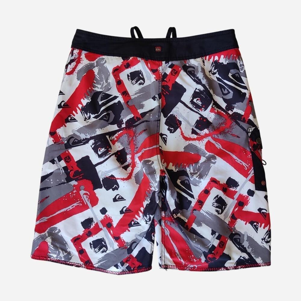 Y2K Quiksilver board shorts with abstract red, black, and gray brushstroke desig